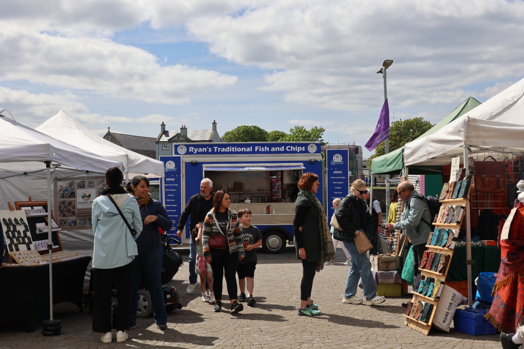 Ryan's Traditional Fish and Chips truck serving a busy market crowd