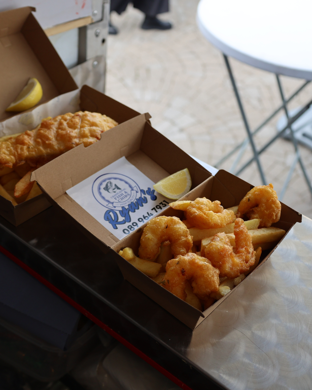 Fresh cod and scampi with chips in Ryan's branded boxes