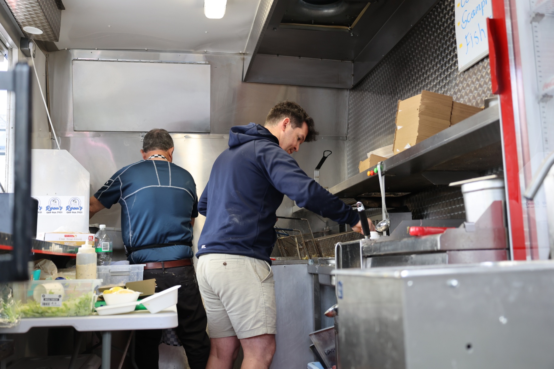 Ryan's team cooking fresh fish and chips inside the mobile kitchen